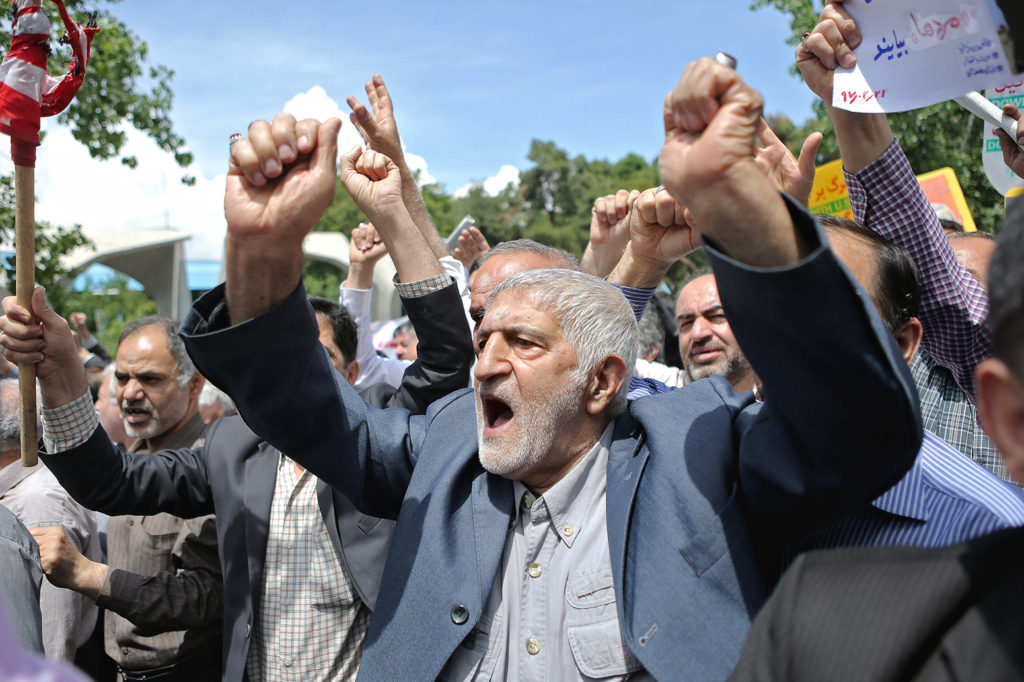 People protest in Tehran against the announcement of the US withdrawal from the Iran nuclear deal, 11 May 2018. Credit: Ahmad Halabisaz/Xinhua/Alamy Live News. MMFYTH